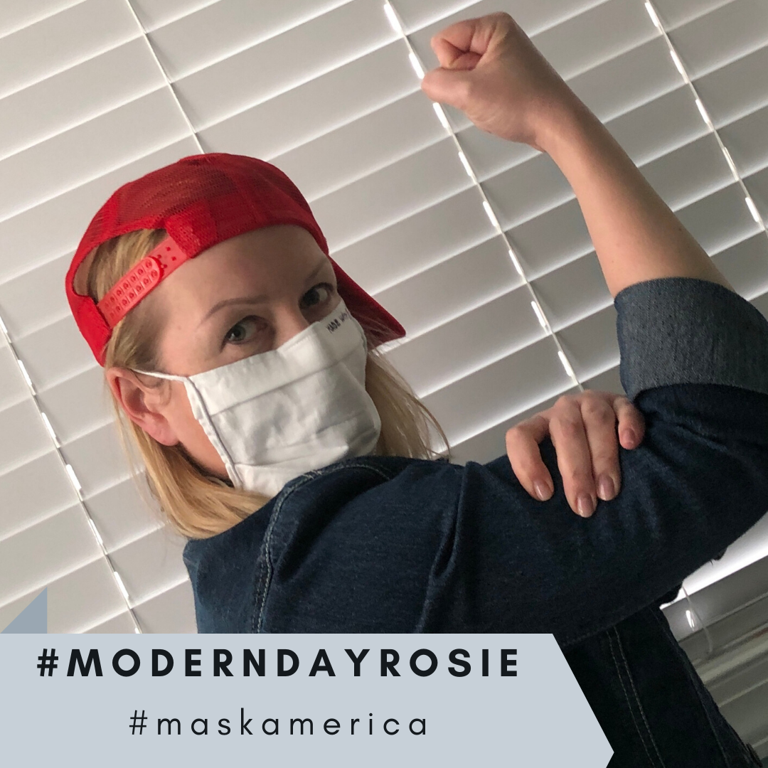 A person poses in front of white blinds, flexing an arm with a bent elbow in a "We Can Do It!" stance. They wear a red backward cap, a white face mask, and a blue top, symbolizing modern mask-making efforts. Hashtags #MODERNDAYROSIE and #MaskAmerica are prominently displayed at the bottom.