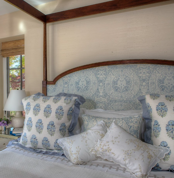 On-site installed custom upholstered headboard, proportioned to align with detailed architectural millwork and integrated window treatments.