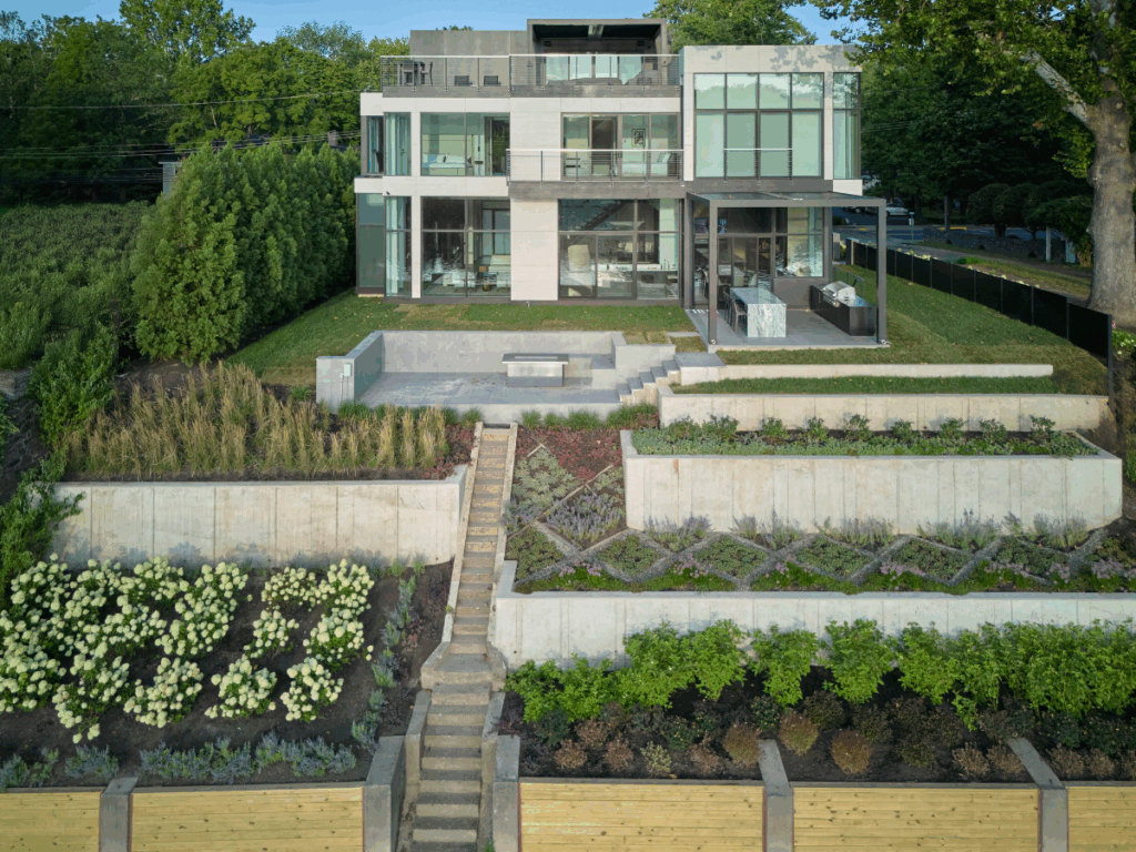 Multi-tiered landscape and outdoor hardscape designed by PLANT Design Group, complementing the modern architecture in New Hope.