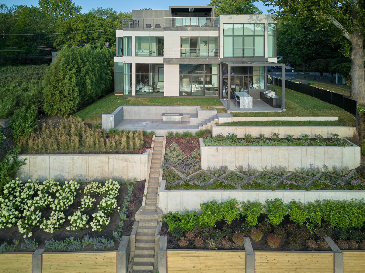Multi-tiered landscape and outdoor hardscape designed by PLANT Design Group, complementing the modern architecture in New Hope.