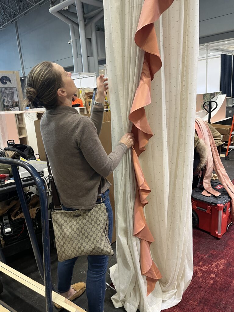 Installing custom drapery panels at Javits Center for BDNY 2025
