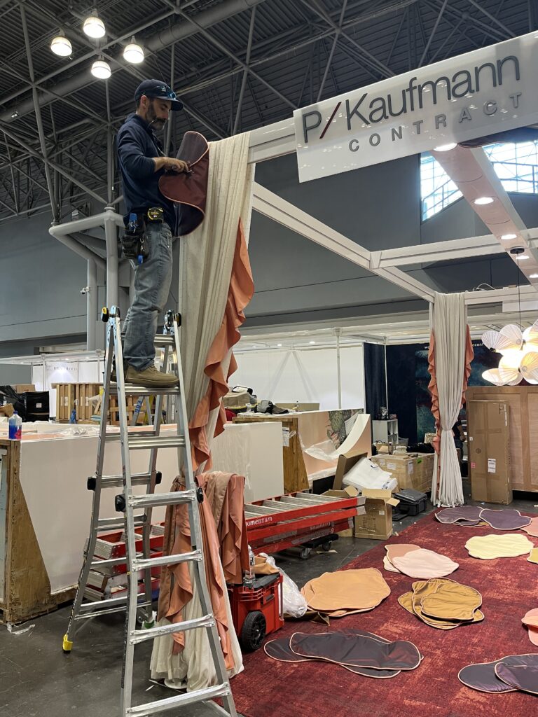 Installing custom drapery panels at Javits Center for BDNY 2025