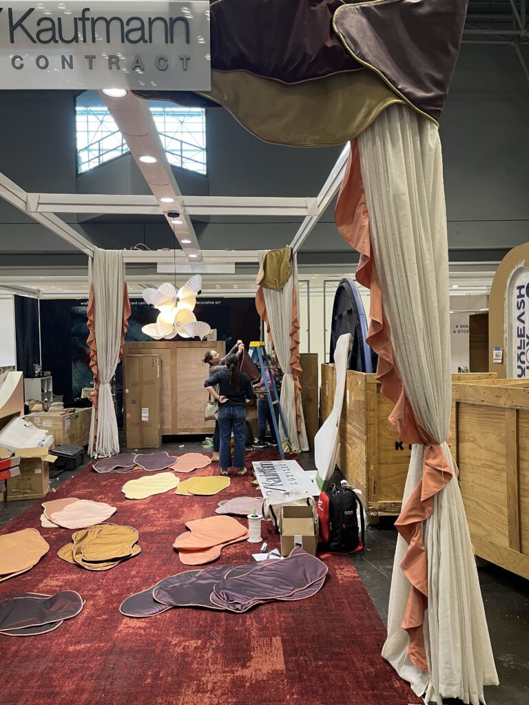 Installing custom drapery panels at Javits Center for BDNY 2025