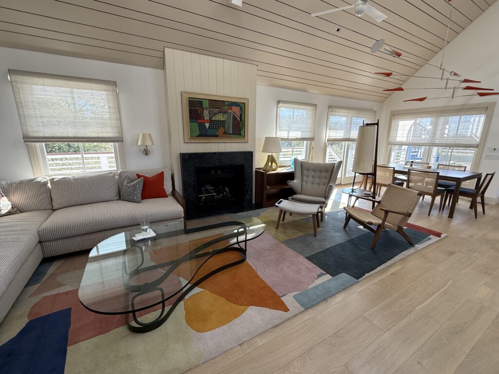 Conrad Moondust woven wood shades on motorized track in coastal living space, custom window treatments by Vitalia Inc