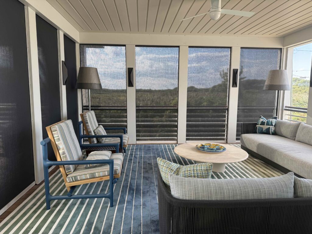 Motorized exterior zip shades on covered porch overlooking South Cape May Meadows Preserve, Crown Shade Company Suntex 97, installed by Vitalia Inc